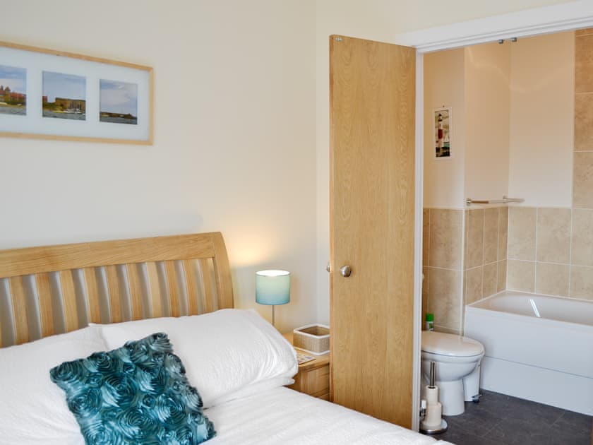 Double bed and en-suite with shower over bath and toilet | Sea Breeze, Beadnell, near Seahouses
