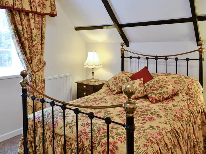 Exposed wood-beam featured ceiling in double bedroom | Y Bwthyn, Bala