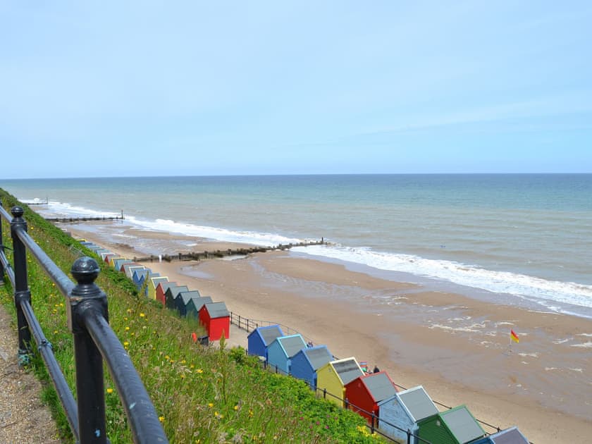 The coastline with beach-huts | Wallages Cottage - White House Farm Holiday Cottages, Knapton, near North Walsham