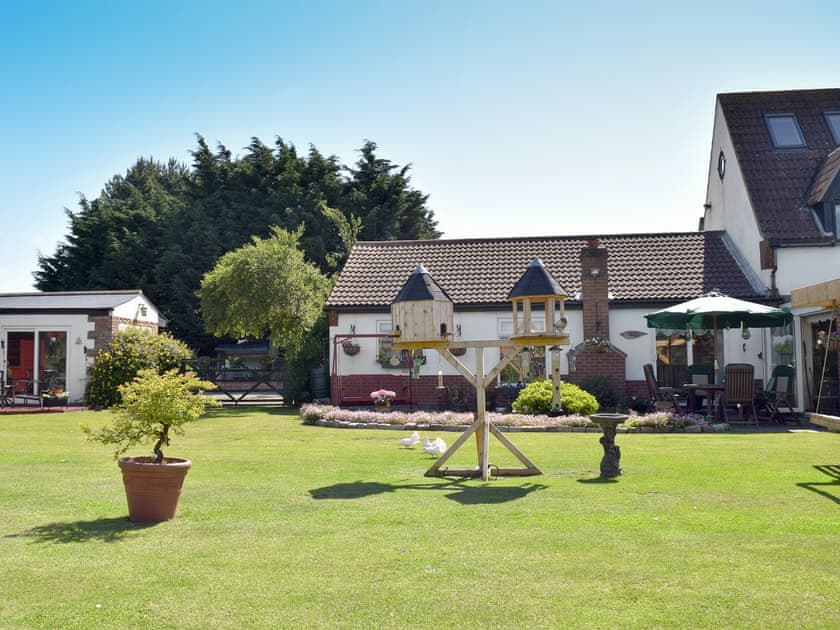 Spacious garden and grounds | Leanda Lodge, Burgh Castle, near Great Yarmouth