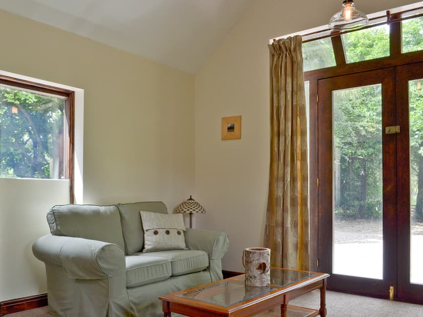Thoughtfully renovated living room with woodburner | Waterfall Cottage - Lumsdale Cottages, Lumsdale, Tansley Wood, near Matlock