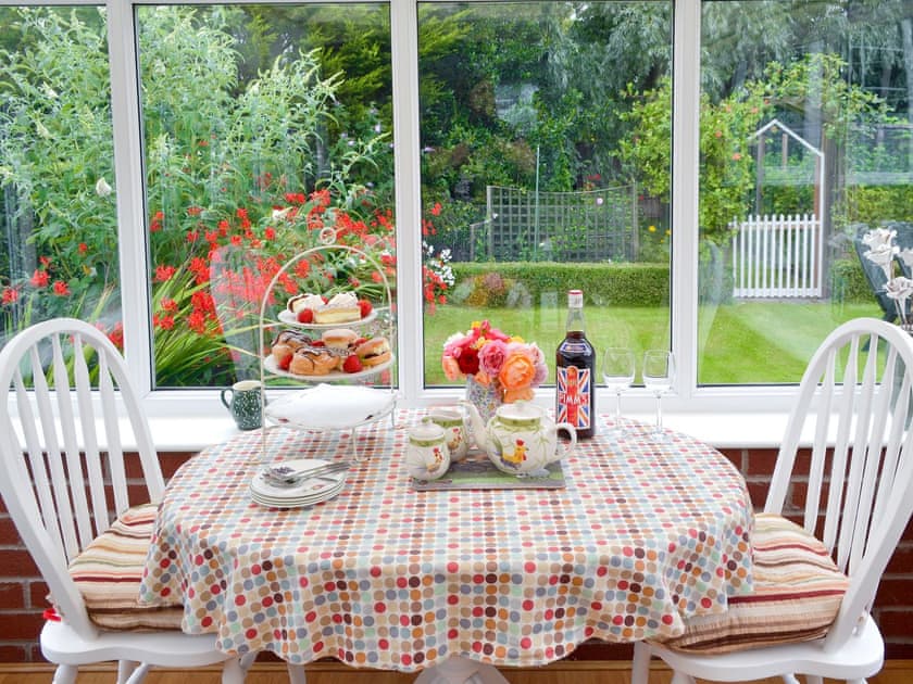 Delightful dining area in the conservatory | Rose Cottage, Scarisbrick, near Southport 