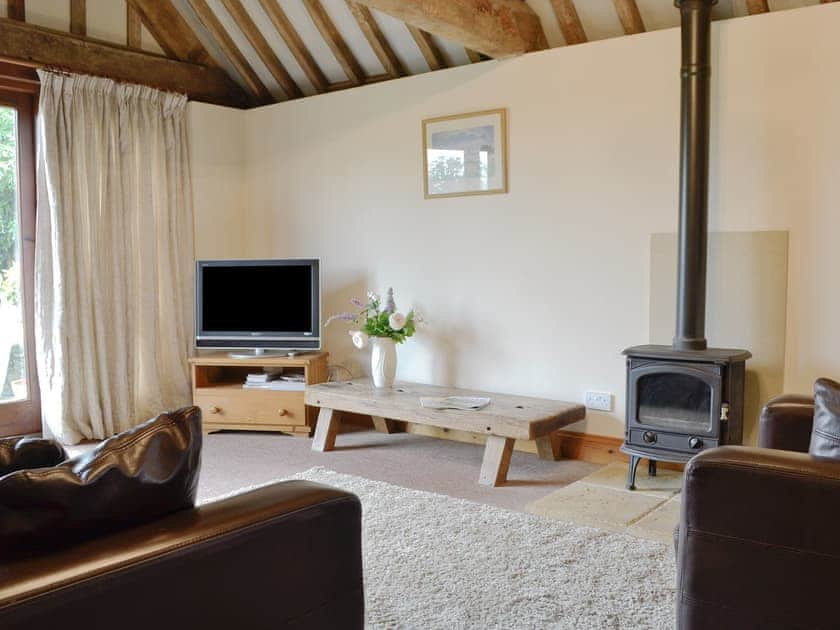 Cosy living area with wood burner | The Carthouse, Lea, Malmesbury