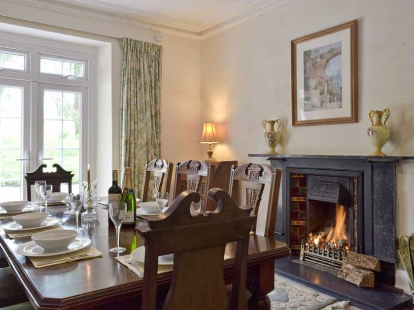 Formal dining room with French doors to garden | Tan Y Castell, Llanmill, near Narberth