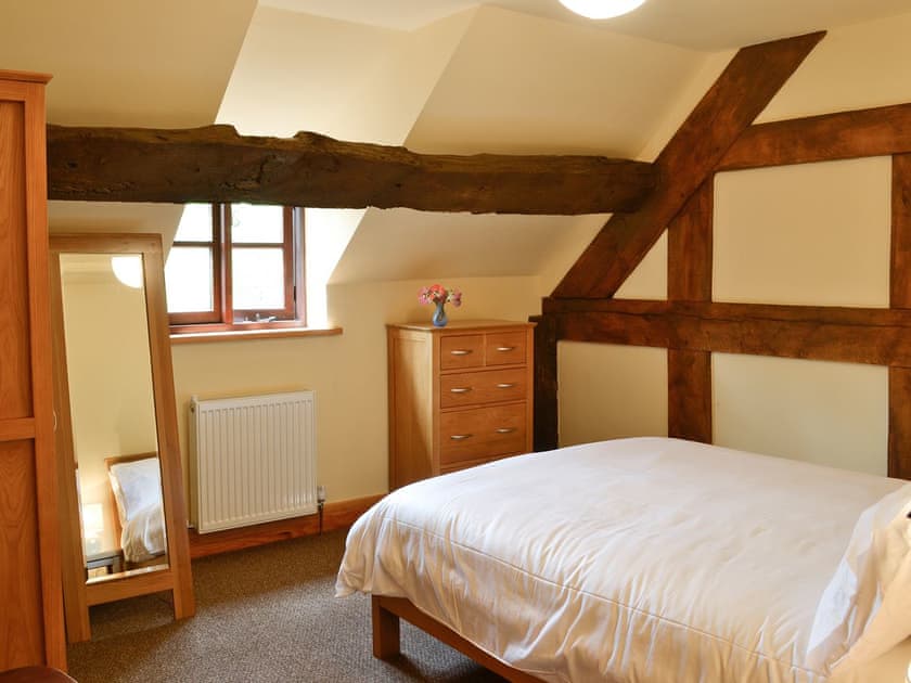 Double bedroom with exposed wooden beams | Mill Cottage, Peterchurch, near Hay-on-Wye