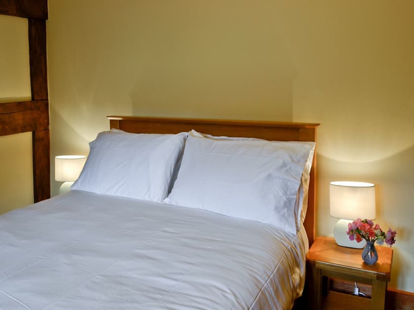 Double bedroom with exposed wooden beams | Mill Cottage, Peterchurch, near Hay-on-Wye