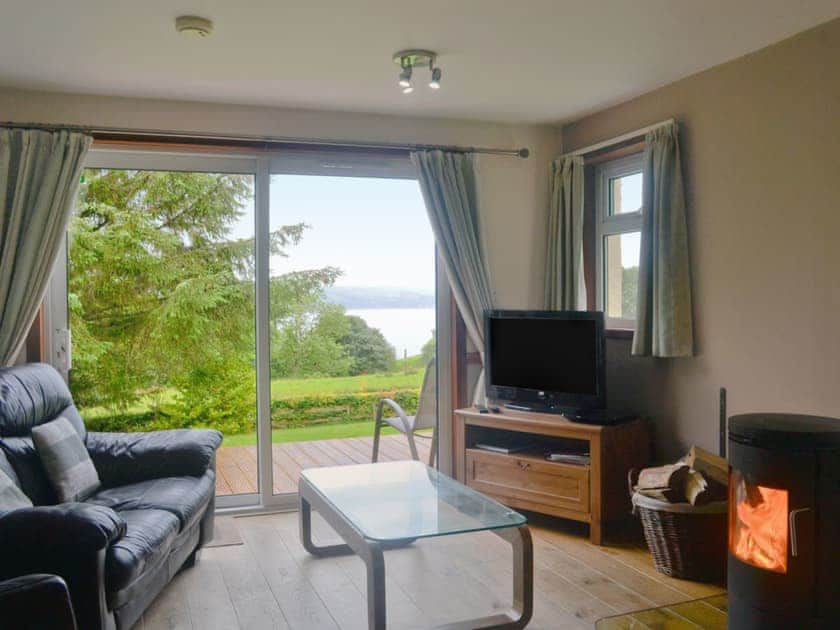 Cosy living room with wonderful views of Loch Long  | Larch Cottage - Stronchullin Holiday Cottages, Blairmore, near Dunoon