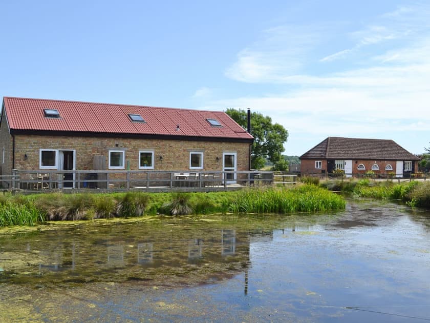 View of all 4 properties situated on the edge of a beautiful pond | Romney Cottages - The Wagon Lodge, Peasmarsh, nr. Rye