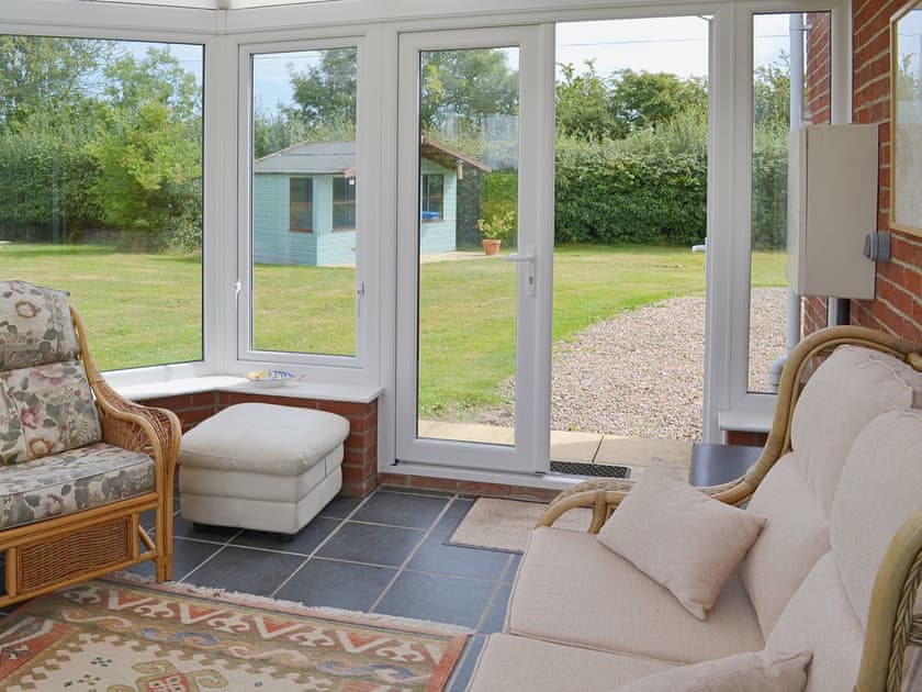 Cosy tile-floored conservatory | Daisy Apartment - Chapelfield Apartments, Stalham