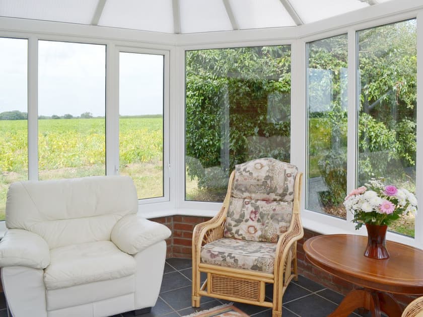 Conservatory with far-reaching views over the countryside | Daisy Apartment - Chapelfield Apartments, Stalham
