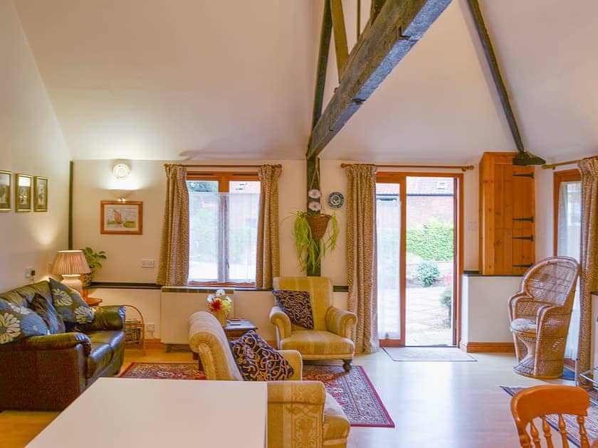 Comfortable open plan living area with exposed woodwork | Church Farm Studio, Surlingham