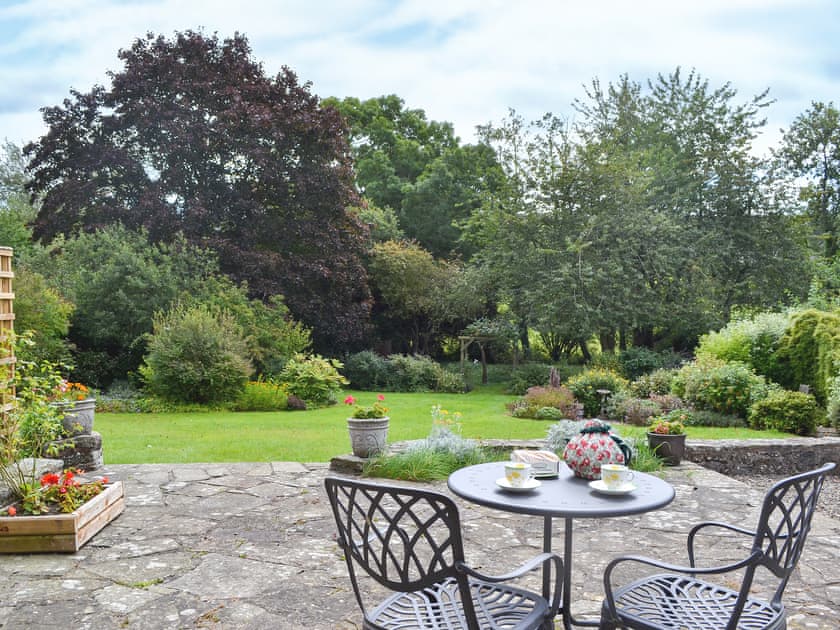 Private patio leading out to large, spacious, shared lawned garden | The Bothy, Clun, near Craven Arms