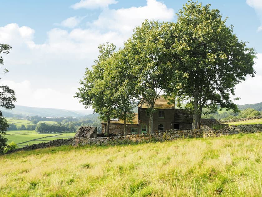 The cottage nestles in a small grove of trees  | Wickwoods, Wath, near Pateley Bridge