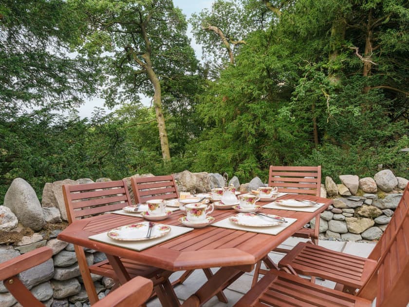 Outdoor dining area in the garden | Waterfall Wood Cottage, Glenridding, by Ullswater