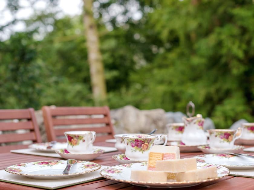 Outdoor dining area in the garden | Waterfall Wood Cottage, Glenridding, by Ullswater
