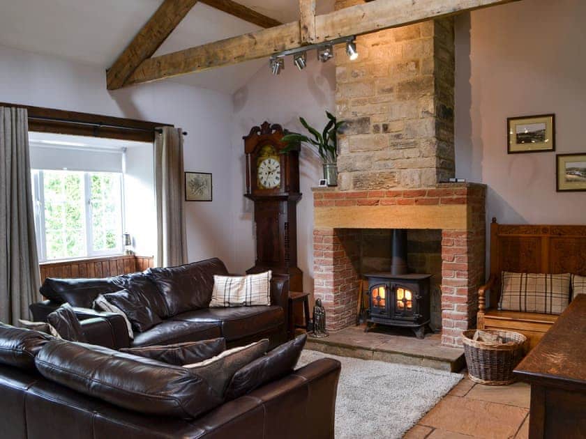 Cosy lounge with wood burning stove & wood beamed ceiling  | Old Kielder Castle Cottage, Kielder, near Bellingham