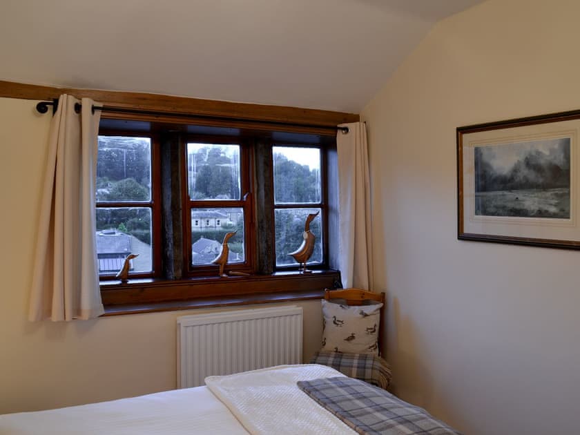 Double bedroom with mullioned windows | Eider Cottage, Holmfirth
