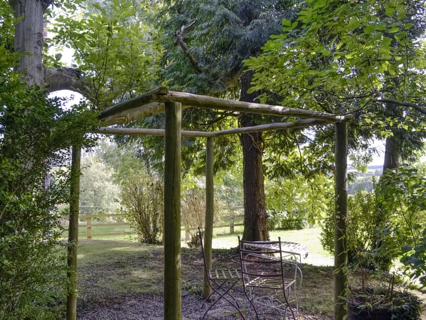 Additional seating area within garden | The Old Winery Cottage, Newent