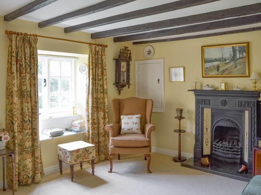 Exposed wooden beams and feature fireplace in living room | , 