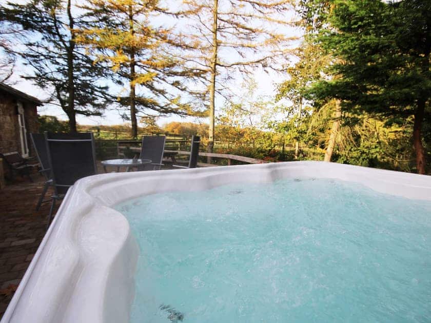 Relax in the private Jacuzzi hot tub | Nuthatch Cottage - Wallace Lane Farm Cottages, Brocklebank, near Caldbeck and Uldale
