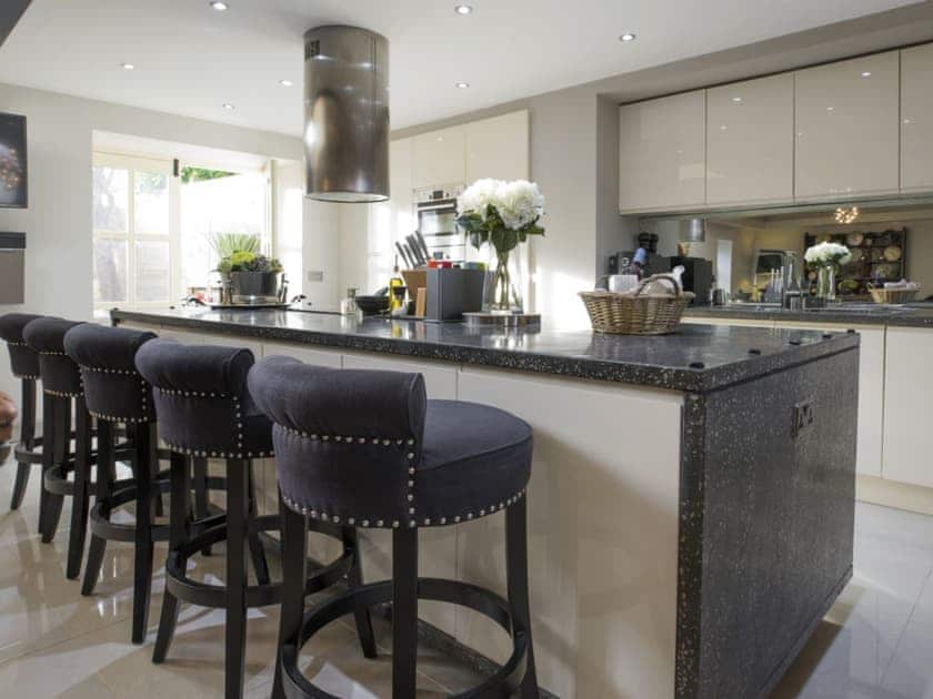 State of the art kitchen with island with French doors leading to a rear courtyard/patio | Old Chapel House, Barnoldswick