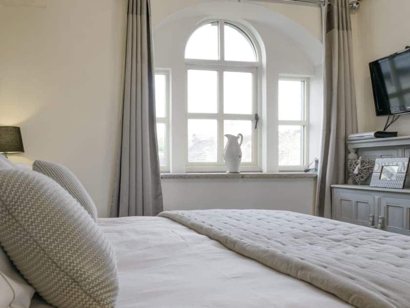 Wall mounted TV within master bedroom | Old Chapel House, Barnoldswick