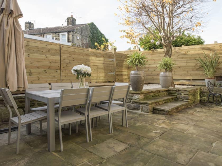 Enclosed rear courtyard with outdoor furniture | Old Chapel House, Barnoldswick