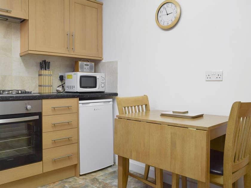 Intimate dining area situated within kitchen | Laal Yan, Keswick