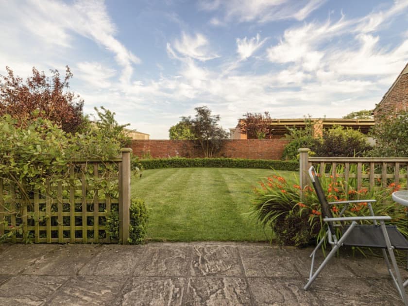 Patio and lovely lawned garden | Stables Cottage - Mackinder Farms, Brayton, Selby