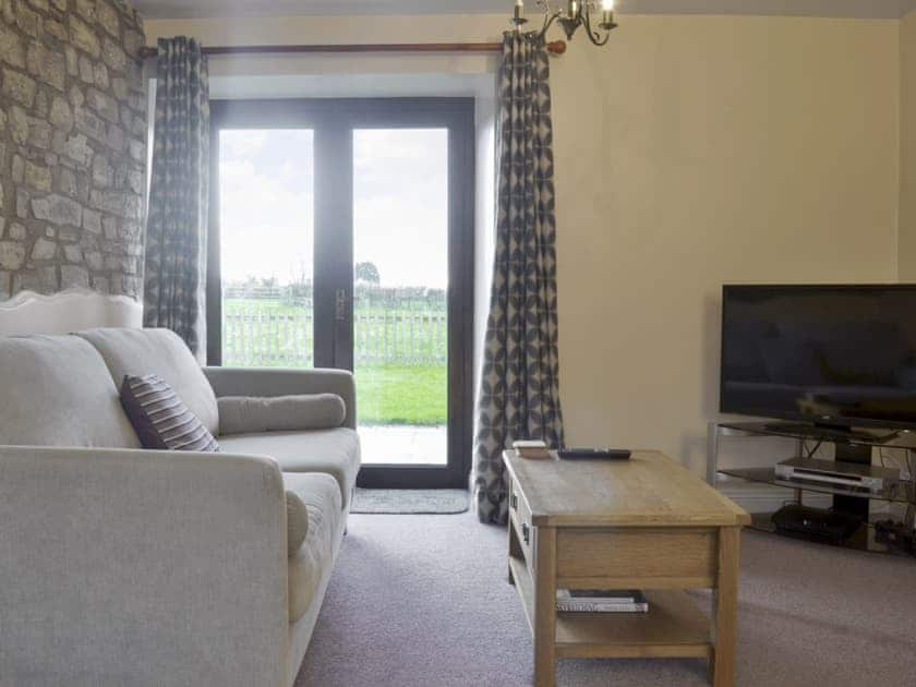 Living room with patio doors to sitting out area | The Creamery, North Wootton, near Wells