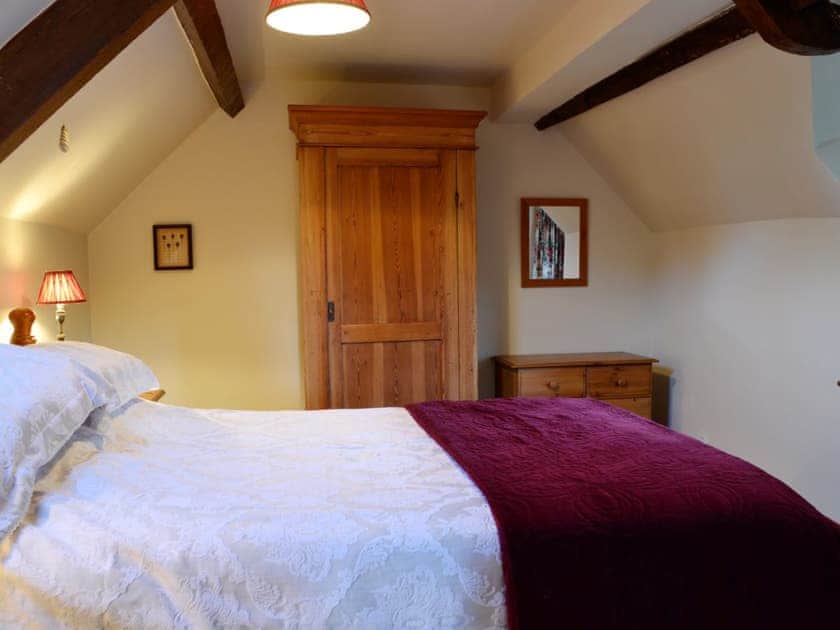 Quirky double bedroom with slopoing ceilings | The Cot, Bussage, near Cirencester