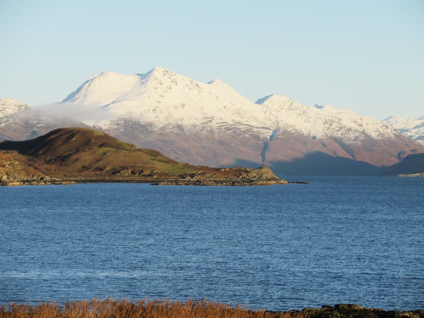 View of the adjacent snow-capped mountains | South Bay Cottage, Saasaig, Teangue, Isle of Skye