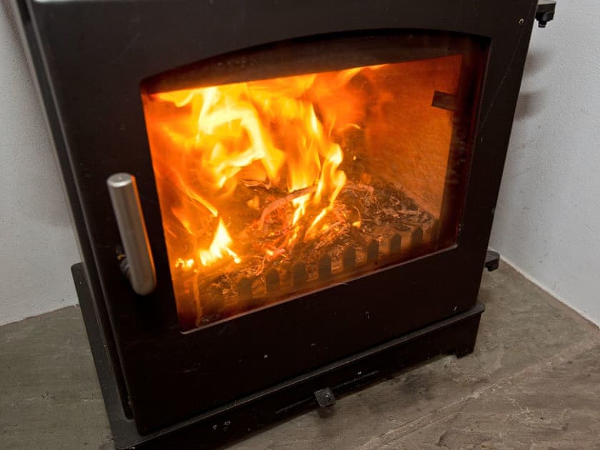 Wood burning stove in the living room | 22 Rose Terrace, Keswick