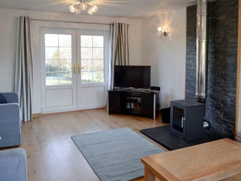 Living room with stylish wood burner | Carron House, Slumbay, near Lochcarron