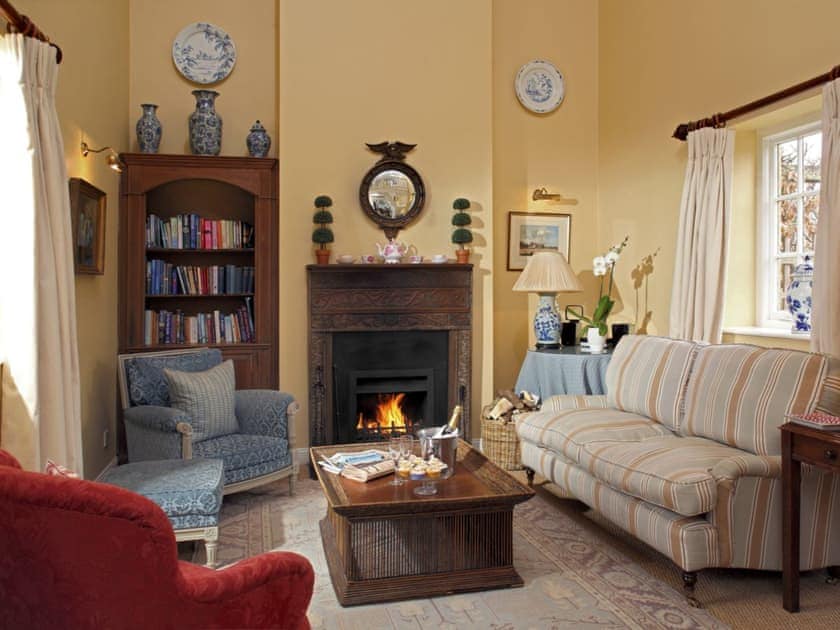 Elegant living area with ‘real’ open fire | Saratoga - Bruern Holiday Cottages, Bruern, near Chipping Norton