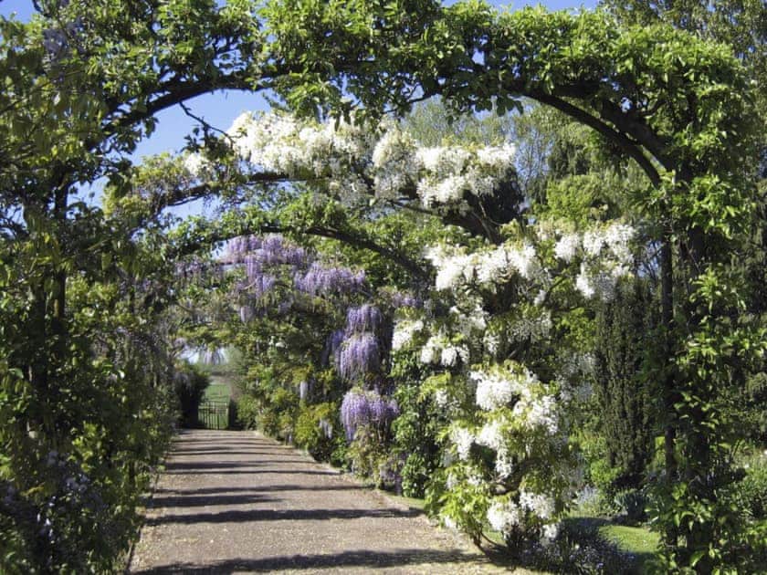 Relaxing walkway through the garden arches | Bruern Holiday Cottages, Bruern, near Chipping Norton
