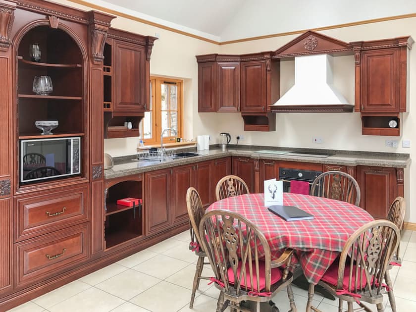 Dining area and adjacent kitchen in the open plan living area | Turin Nurin Cottage, Tomatin, near Inverness