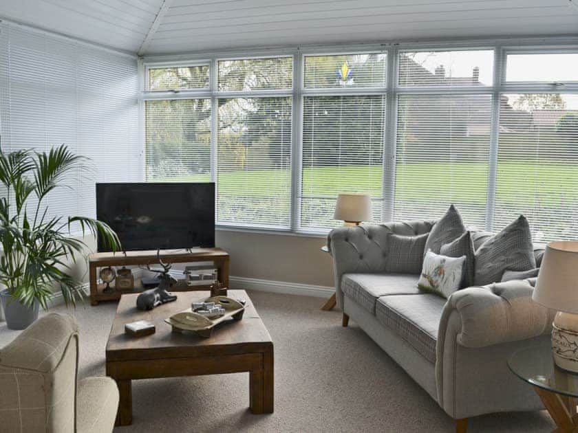 Tastefully furnished living room with French doors leading to the patio | Elm Tree Cottage at Cottage Farm - Cottage Farm, Foxholes, near Scarborough