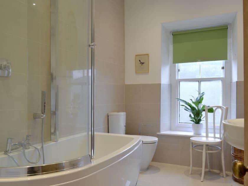 Bathroom with shower over bath | Tyllwyd Farmhouse, Capel Bangor, near Aberystwyth