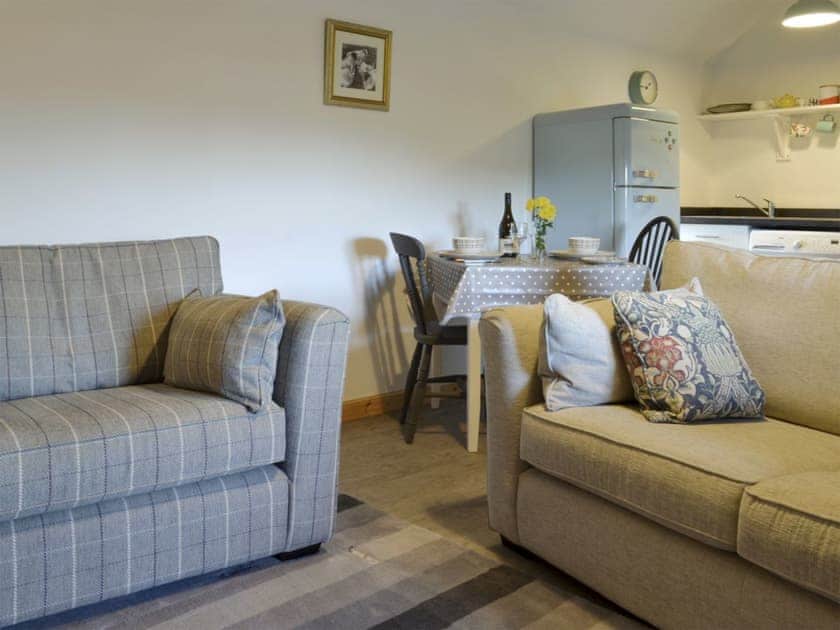 Comfy seating in open-plan living space | Mary’s Cottage, Clachan, Staffin