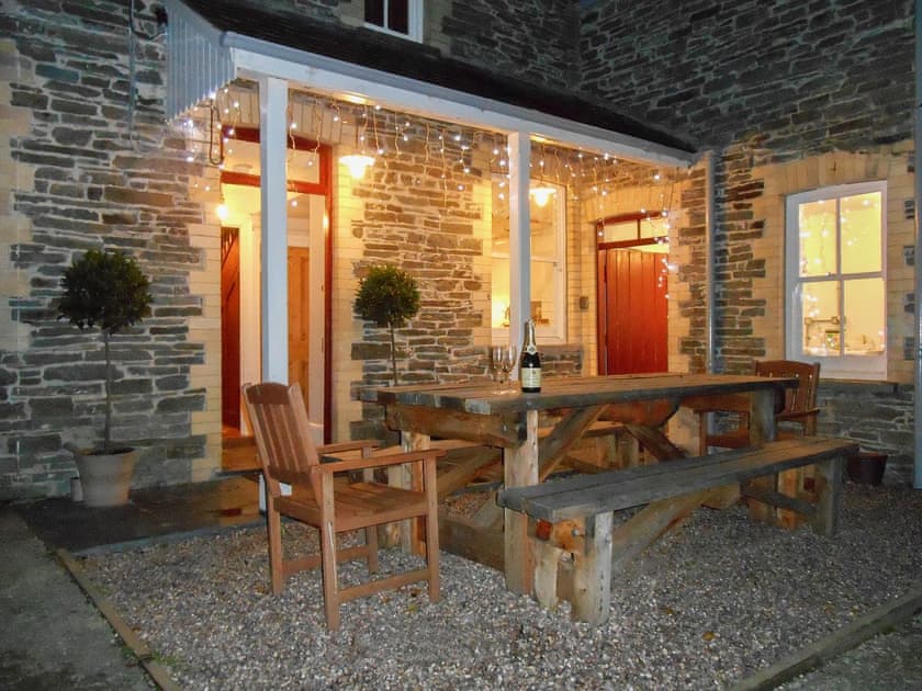 Outdoor seating area at night | Tyllwyd Farmhouse, Capel Bangor, near Aberystwyth