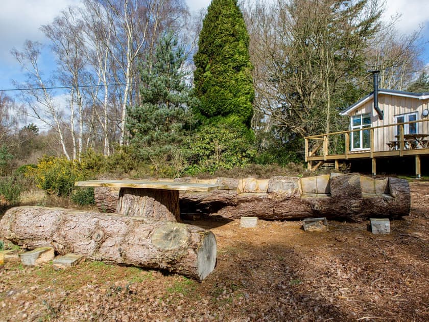 Rustic outdoor furniture within garden | The Retreat, Aldringham, near Aldeburgh