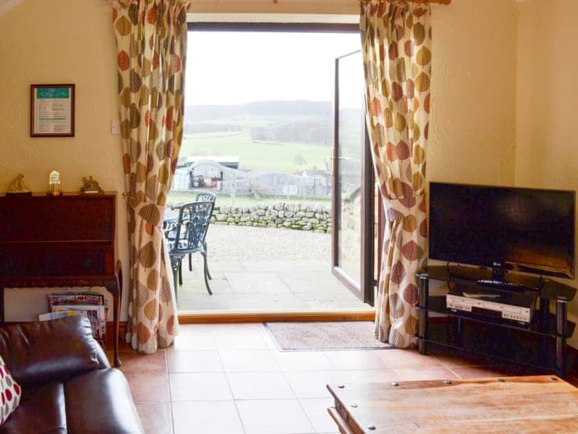 Living room with French doors to patio | Ellis Close Farm - Swallows Nest - Ellis Close Farm Cottages, Harwood Dale, near Scarborough