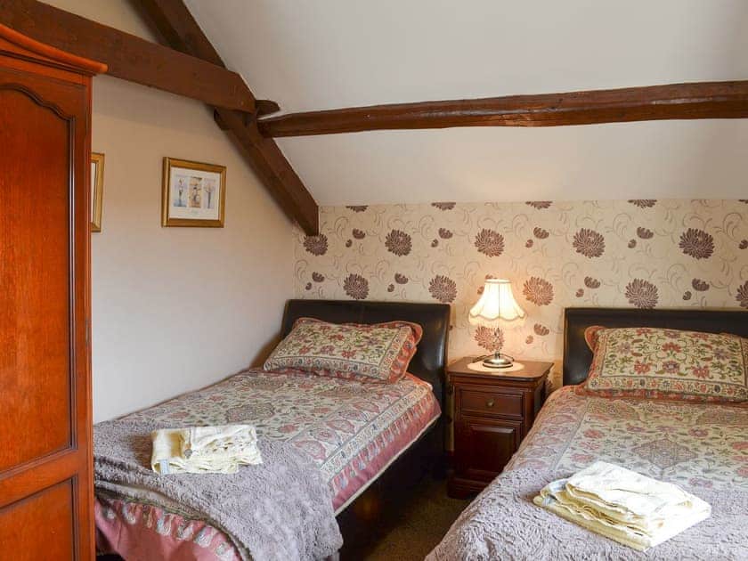 Twin bedroom with beams and a sloping ceiling | Ellis Close Farm - Batty Barn - Ellis Close Farm Cottages, Harwood Dale, near Scarborough