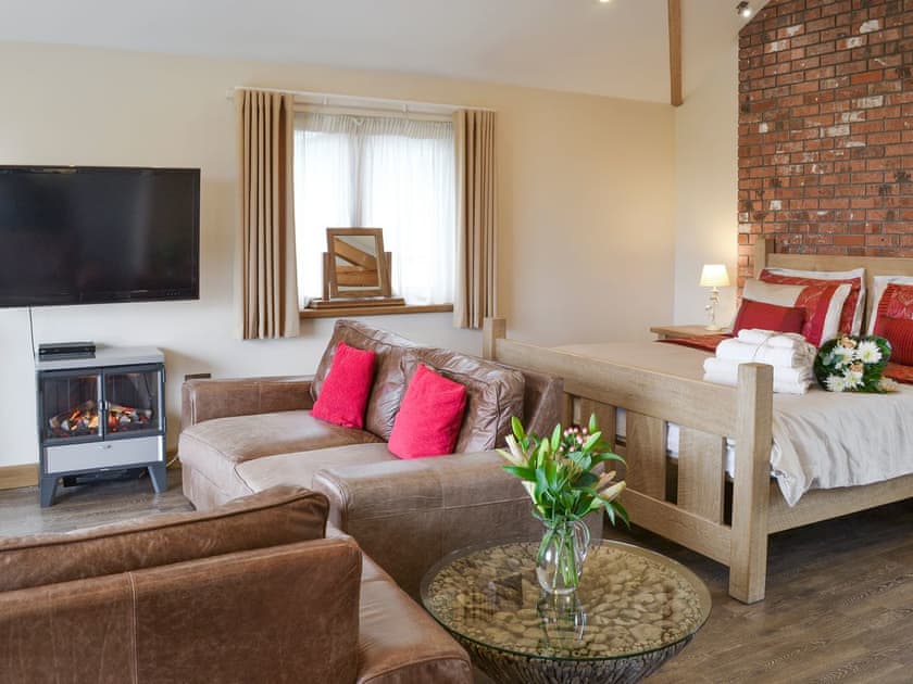Warming wood-burner in living area | Shooting Star - Wooldown Holiday Cottages, Marhamchurch, near Bude