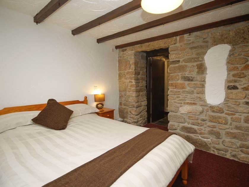 Comfortable double bedroom with exposed stone feature wall | Tamarisk - East Rose, St Breward, near Bodmin