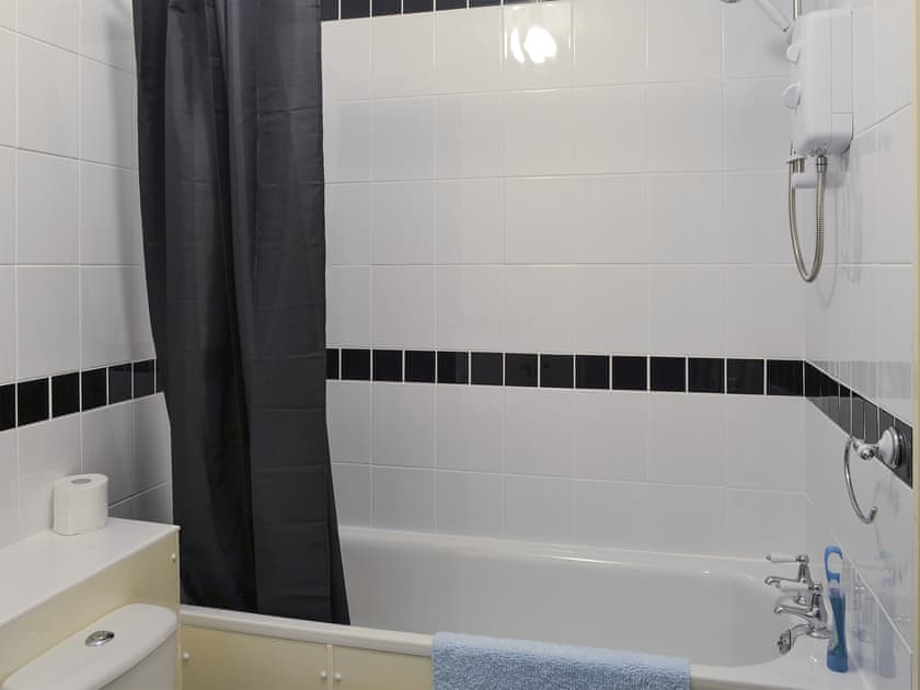 Bathroom with shower over bath  | The Snug - Ty Copr, Pen-y-Sarn, near Amlwch