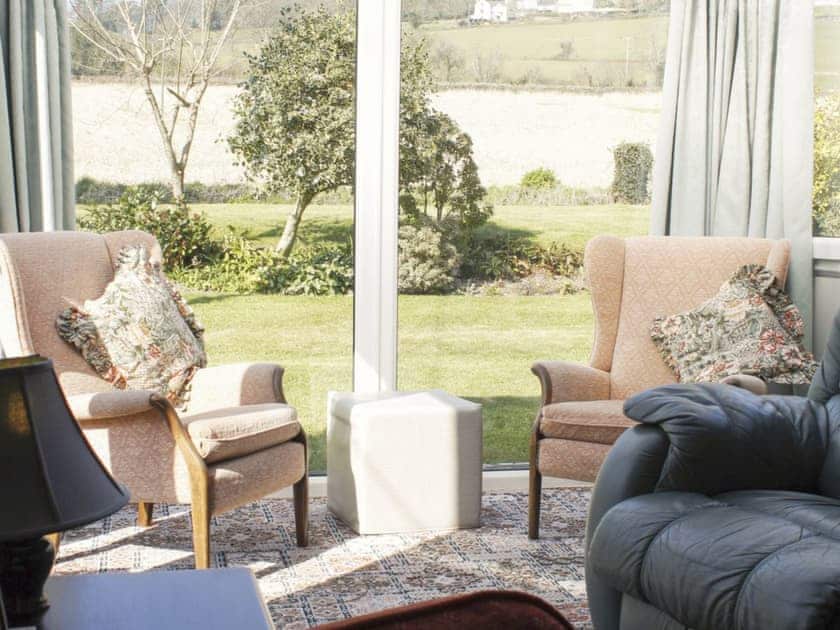 Light and airy sunroom area of living room | Dairy Cottage, Barnstaple