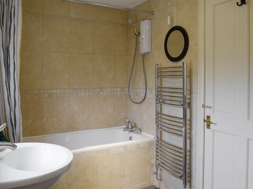 Family bathroom with shower above bath | York House, Hudswell, near Richmond