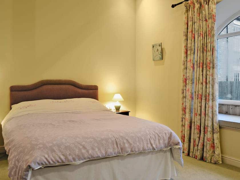 Comfortable double bedroom with en-suite shower room | The Arches - Home Farm Holiday Cottages, Slingsby, near Malton